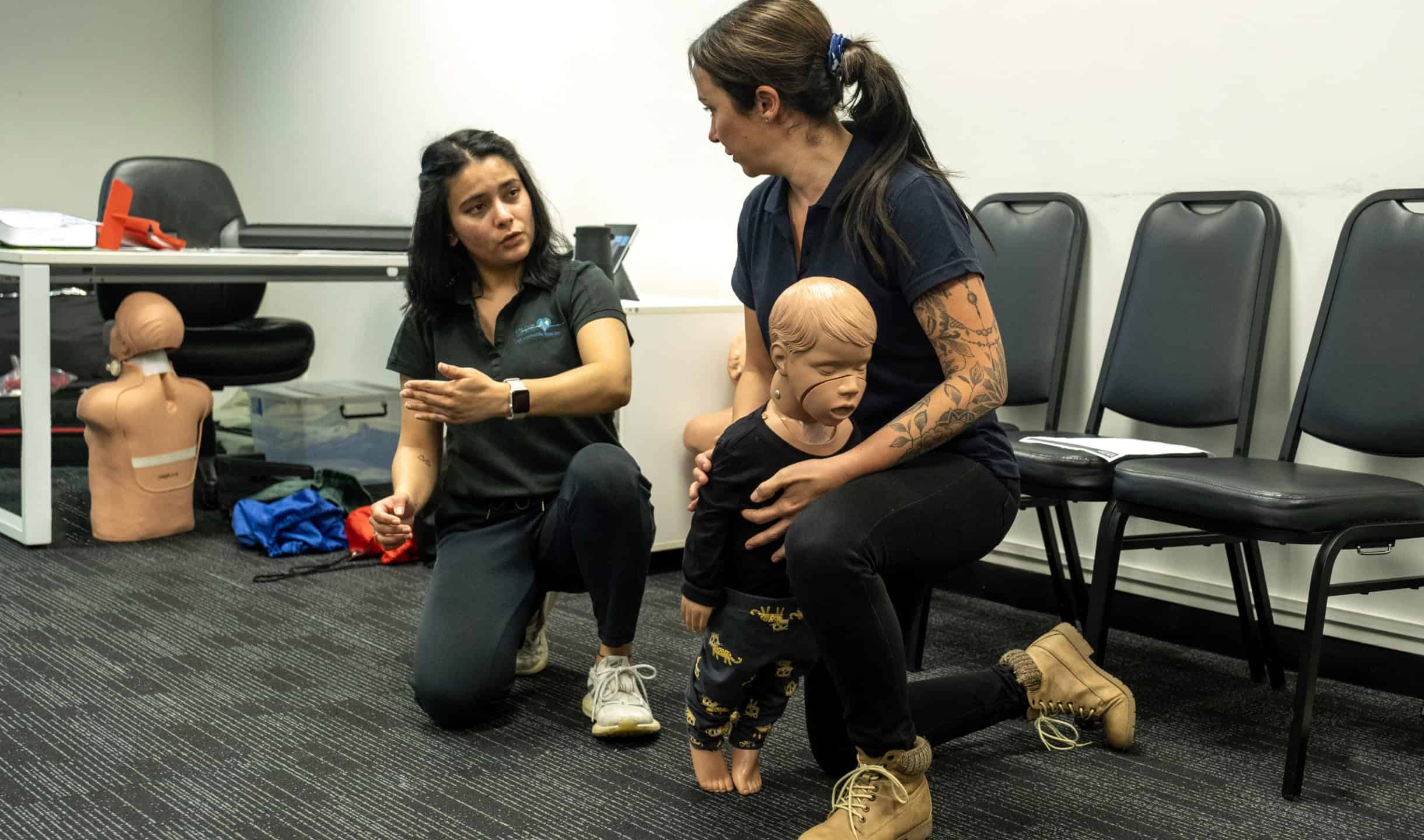 Life Care instructor demonstrating infant first aid techniques during a training session.